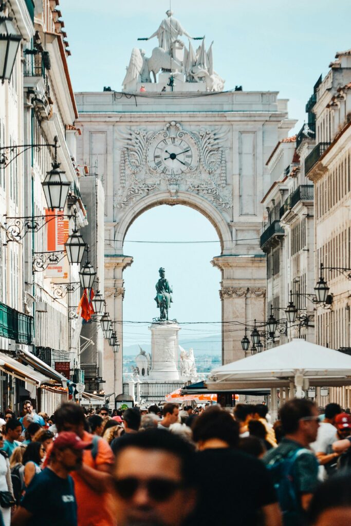 Vibrant street scene at Rua Augusta Arch, Lisbon, filled with tourists and locals.